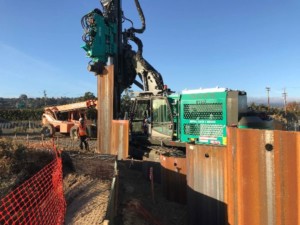 Tractor helping install sheet piles