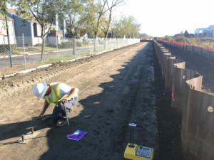 Construction worker evaluates soil